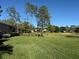 Picturesque golf course view with mature trees, promoting a tranquil and relaxing atmosphere at 1970 Farmington Ct, Clermont, FL 34711