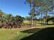 Lush green golf course view, framed by trees and landscaping, offering a serene backdrop at 1970 Farmington Ct, Clermont, FL 34711