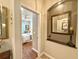 Hallway with decoratively mirrored alcove and view into the main bedroom with ceiling fan at 1970 Farmington Ct, Clermont, FL 34711