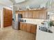 Bright kitchen with tile flooring, stainless steel refrigerator, and a double basin sink at 1970 Farmington Ct, Clermont, FL 34711
