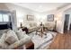 Comfortable living room with wood floors, cozy sofas, and French doors leading to an office at 1970 Farmington Ct, Clermont, FL 34711