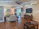 Open living space with hardwood floors, comfortable seating, and a view of the patio and backyard at 1970 Farmington Ct, Clermont, FL 34711