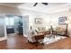 Bright and airy living room with wood floors, sofas, and French doors to an office at 1970 Farmington Ct, Clermont, FL 34711