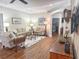 Inviting living room with wood floors, comfortable sofas, and an open view to the dining area at 1970 Farmington Ct, Clermont, FL 34711