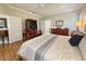 Spacious main bedroom with en suite bathroom, wood-look floors, and neutral walls and crown moulding at 1970 Farmington Ct, Clermont, FL 34711