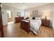 Spacious main bedroom with en suite bathroom, wood-look floors, neutral walls, and crown moulding at 1970 Farmington Ct, Clermont, FL 34711