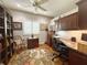 Well-lit home office featuring custom shelving, desk space, and a comfortable chair at 1970 Farmington Ct, Clermont, FL 34711