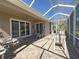Spacious screened patio with seating, overlooking the lush landscape at 1970 Farmington Ct, Clermont, FL 34711