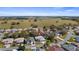 Expansive aerial view of a residential community surrounded by green pastures at 20740 Queen Alexandra Dr, Leesburg, FL 34748