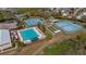 Aerial view of the community pool, tennis courts and recreation facilities near lush landscaping at 20740 Queen Alexandra Dr, Leesburg, FL 34748