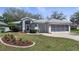 Charming single-story home with a well-manicured lawn and mature landscaping at 20740 Queen Alexandra Dr, Leesburg, FL 34748