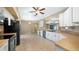 Open kitchen with white cabinetry, tiled floor, stainless steel dishwasher, and black appliances at 20740 Queen Alexandra Dr, Leesburg, FL 34748