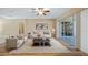 Bright living room with neutral decor and sliding glass doors to the outside at 20740 Queen Alexandra Dr, Leesburg, FL 34748
