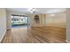 Spacious living area with wood floors and access to the screened lanai at 20740 Queen Alexandra Dr, Leesburg, FL 34748