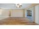 Spacious living room with hardwood floors, ceiling fan, recessed lighting, and access to the outdoor patio at 20740 Queen Alexandra Dr, Leesburg, FL 34748