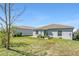 This charming backyard boasts green grass, garden boxes, and a view of neighboring homes at 212 Taft Dr, Davenport, FL 33837