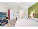 Bedroom features green wall, carpeted floors, and a bed with patterned bedding at 212 Taft Dr, Davenport, FL 33837