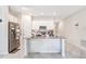 Bright kitchen with stainless steel appliances, center island, and ample counter space at 212 Taft Dr, Davenport, FL 33837