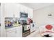 Clean kitchen features white cabinetry, stainless steel appliances, and tile backsplash at 212 Taft Dr, Davenport, FL 33837