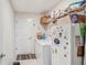 A functional laundry room features tile floors, washer, dryer and shelving space for storage at 212 Taft Dr, Davenport, FL 33837