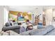 Comfortable living room featuring gray sofas, geometric accent wall and a view into the kitchen at 212 Taft Dr, Davenport, FL 33837