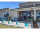 Charming patio with colorful potted plants and seating area overlooking serene water views at 2225 Cypress Ct # 2C, Tavares, FL 32778