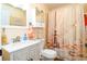 This bathroom features a toilet, sink, vanity, shower with nautical themed shower curtain at 2225 Cypress Ct # 2C, Tavares, FL 32778