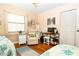 Cozy bedroom featuring a desk and comfortable seating area at 2225 Cypress Ct # 2C, Tavares, FL 32778