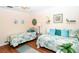 Relaxing bedroom with two twin beds and calming green and blue tones at 2225 Cypress Ct # 2C, Tavares, FL 32778