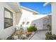 Private courtyard featuring outdoor seating, potted plants and a gated entrance at 2225 Cypress Ct # 2C, Tavares, FL 32778