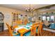 Bright dining room with wooden furniture, hutch, and accents, with views into the living room at 2225 Cypress Ct # 2C, Tavares, FL 32778
