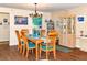 Charming dining room featuring a chandelier, wooden table set, and adjacent kitchen space at 2225 Cypress Ct # 2C, Tavares, FL 32778