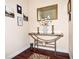 Inviting entryway with stylish console table, decorative mirror, and artwork at 2225 Cypress Ct # 2C, Tavares, FL 32778