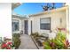 Charming front entry with garden, walkway, seating, and cheerful decor enhancing curb appeal at 2225 Cypress Ct # 2C, Tavares, FL 32778