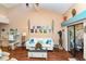 Bright living room with a beach-themed wall mural, vaulted ceiling, and comfortable seating at 2225 Cypress Ct # 2C, Tavares, FL 32778