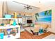 Cozy living room with a beach-themed wall mural, vaulted ceiling, and comfortable seating at 2225 Cypress Ct # 2C, Tavares, FL 32778
