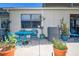 This patio is set with a table, chairs and several potted plants offering a great outdoor living space at 2225 Cypress Ct # 2C, Tavares, FL 32778