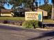 Cypress Cove Condominiums has mature landscaping around the entry sign at 2225 Cypress Ct # 2C, Tavares, FL 32778