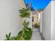 Charming walkway leading to a gated courtyard featuring vibrant plants and a cozy seating area at 2225 Cypress Ct # 2C, Tavares, FL 32778
