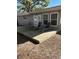 Back patio with lounge chairs offers a relaxing outdoor space to enjoy the sunshine at 2416 Briarwood Ln, Eustis, FL 32726