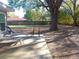 Expansive backyard with mature tree, patio chairs and view of the fence line at 2416 Briarwood Ln, Eustis, FL 32726