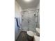 Bathroom featuring a fully enclosed glass shower with white subway tile and modern fixtures at 2416 Briarwood Ln, Eustis, FL 32726