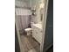 Neat bathroom with neutral accents, decorative shelves, white vanity, toilet, and shower curtain at 2416 Briarwood Ln, Eustis, FL 32726