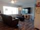 Comfortable living room with hardwood floors, a ceiling fan, and a large flat screen television at 2416 Briarwood Ln, Eustis, FL 32726
