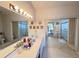 Bright primary bathroom boasts dual sinks and walk-in shower at 25527 Oak Aly, Leesburg, FL 34748