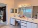 Dual sinks, vanity, and separate shower in this functional bathroom at 25527 Oak Aly, Leesburg, FL 34748