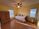 Bedroom features a daybed, wood floors, and dual windows at 25527 Oak Aly, Leesburg, FL 34748