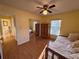 Cozy bedroom with daybed, wood floors, closet, and ample natural light at 25527 Oak Aly, Leesburg, FL 34748