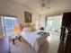Bright bedroom featuring a white comforter and view to the lanai at 25527 Oak Aly, Leesburg, FL 34748