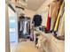 Organized walk-in closet with hanging clothes and shelving at 25527 Oak Aly, Leesburg, FL 34748